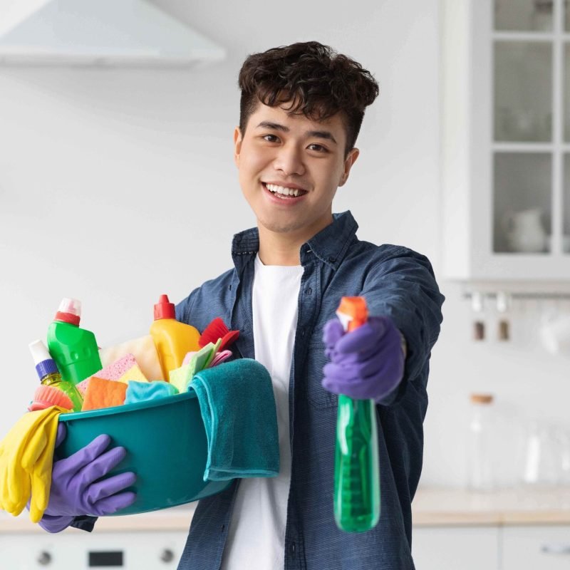 handsome-asian-guy-showing-his-cleaning-tools-2023-11-27-05-11-19-utc