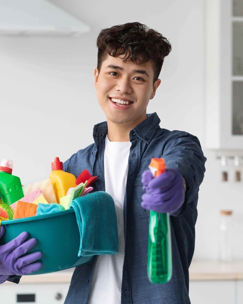 handsome-asian-guy-showing-his-cleaning-tools-2023-11-27-05-11-19-utc